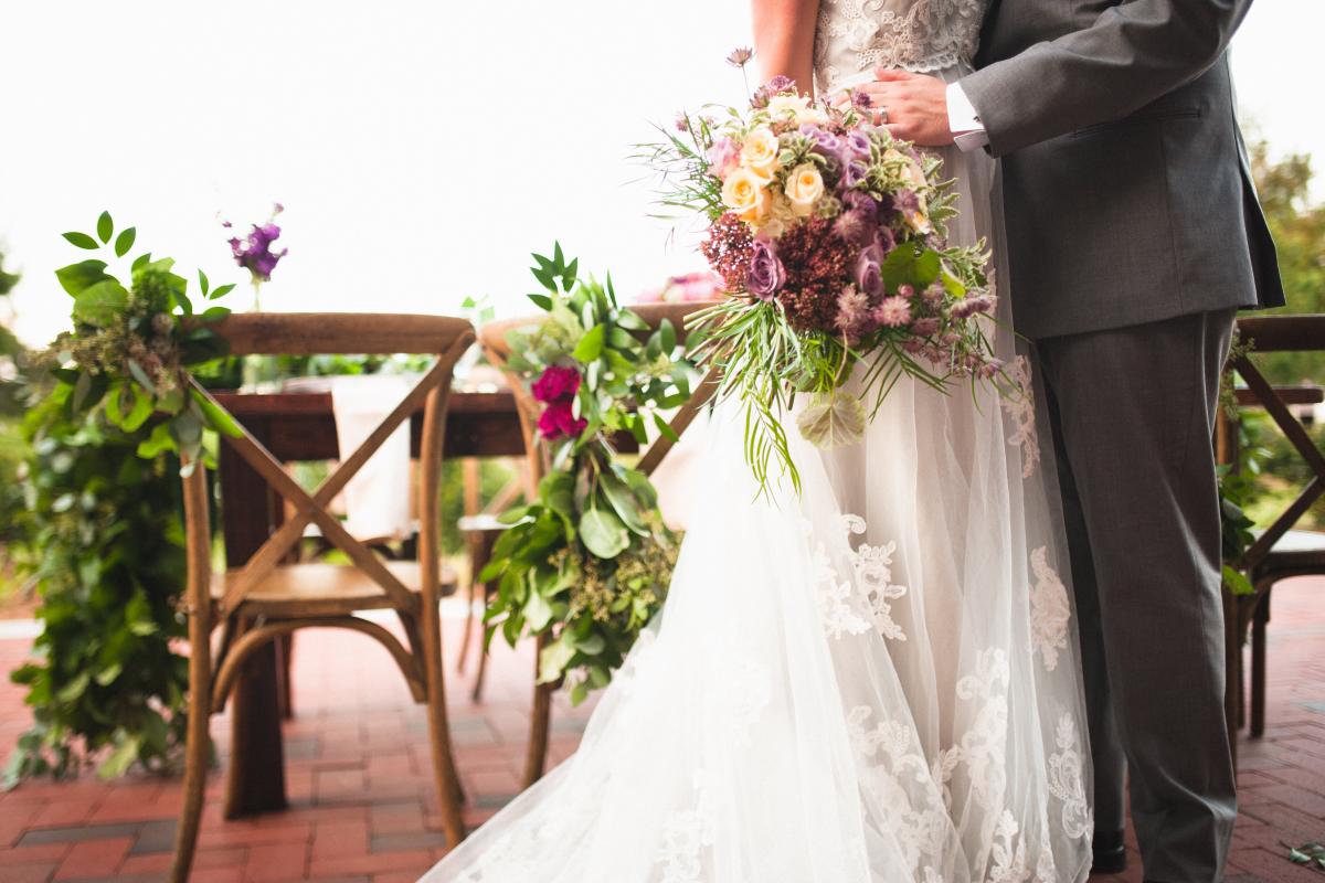 Bride and Groom in Front of Table, Bride Holding Bouquet