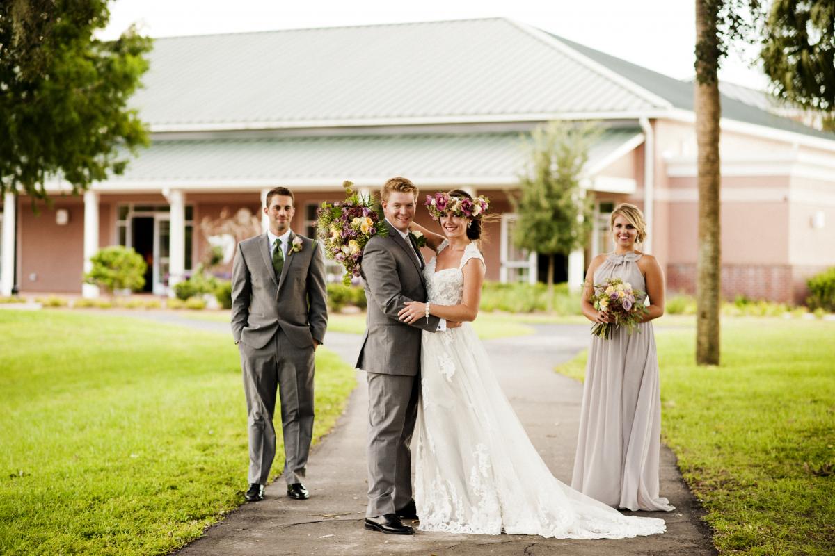 Bride and Groom and Members of Wedding Party in Front of Sanborn Center